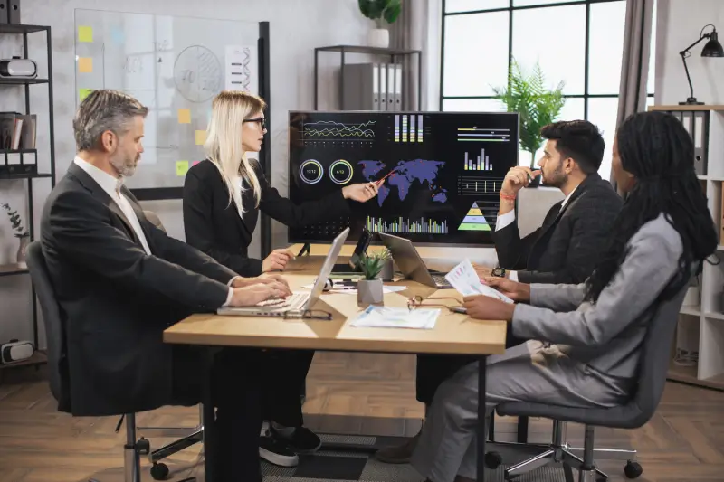 pretty concentrated female boss leader meeting together with her diverse multiracial colleagues