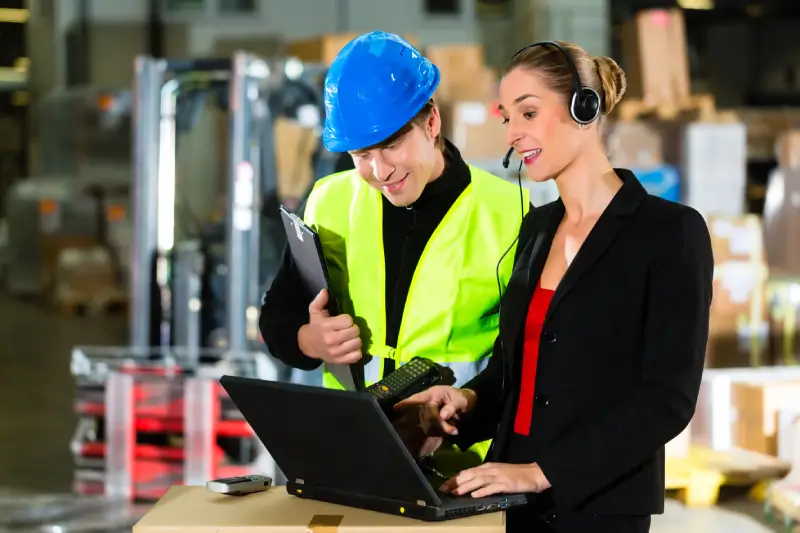 teamwork warehouseman forklift driver female supervisor with laptop headset cell phone warehouse freight forwarding company forklift
