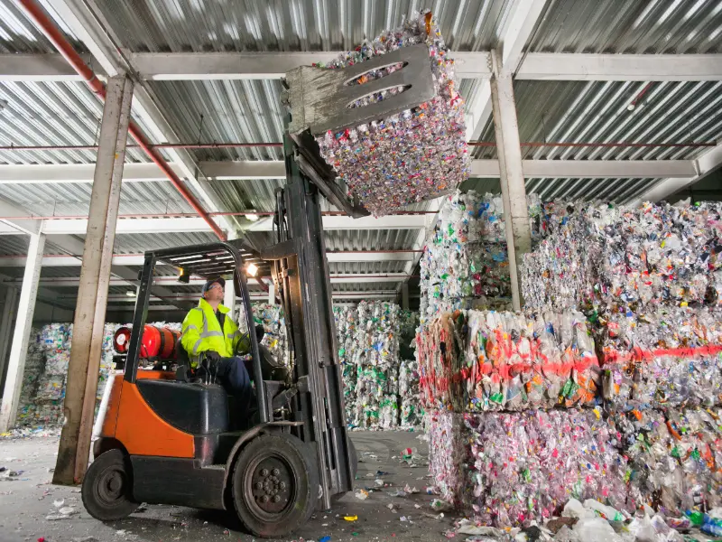 forklift operator lifting bale of recycled plastic 2026 01 11 09 45 30 utc